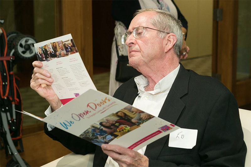 Ed Brown views an ARTZ Philadelphia pamphlet with a look of careful consideration