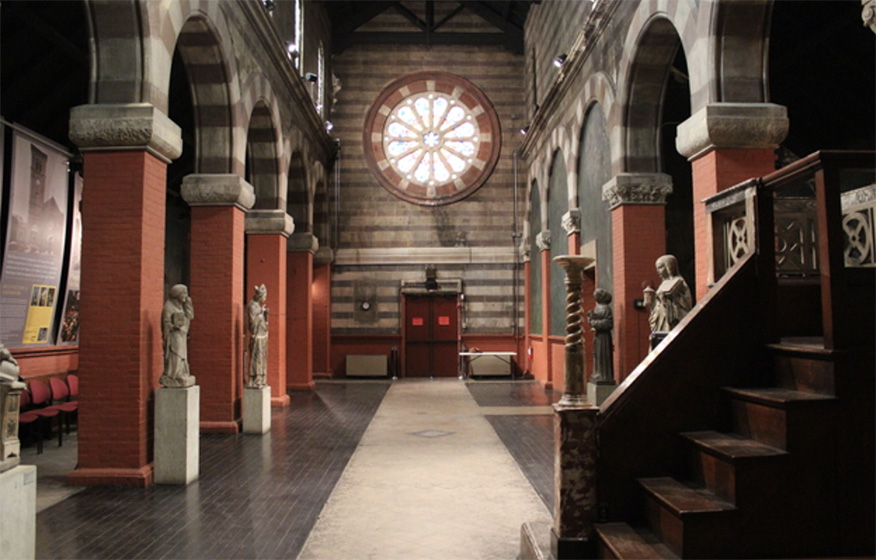 The interior of Fleisher art memorial with a large circular window at center and decorative brick work