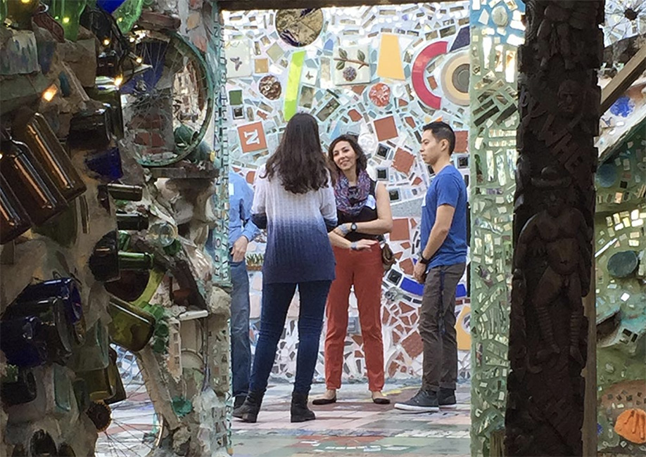 Mike and Maggy stand in Philadelphia's Magic Gardens and talk to other participants