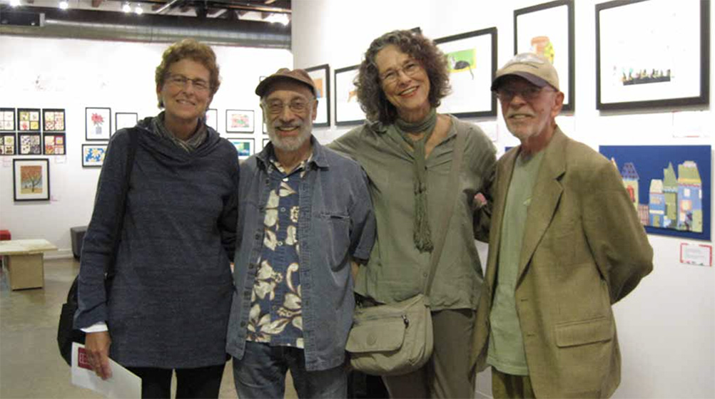 ARTZ participants Kay, Carl, Susan, and Rick stand smiling in an art exhibition