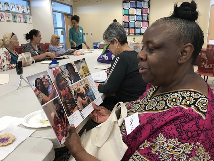 An ARTZ participant pages through the ARTZ in the Neighborhood flipbook